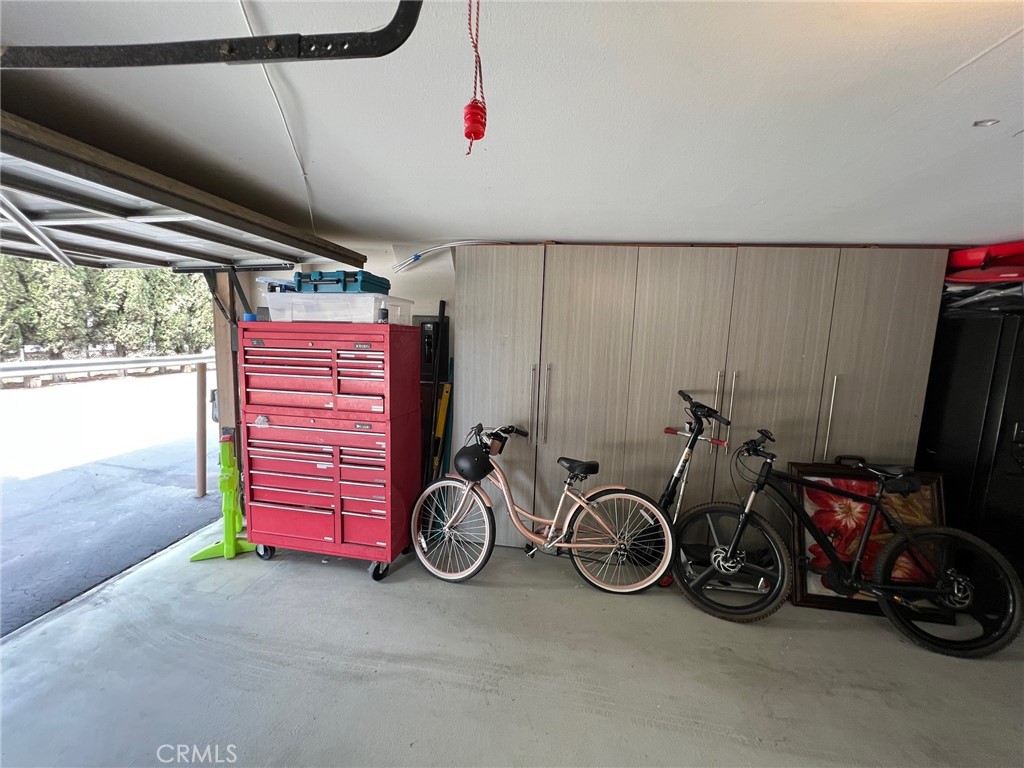 18146 Oxnard Street, Unit 48 Tarzana, CA 91356 - Photo 39 of 52 a view of a garage with a white car parked