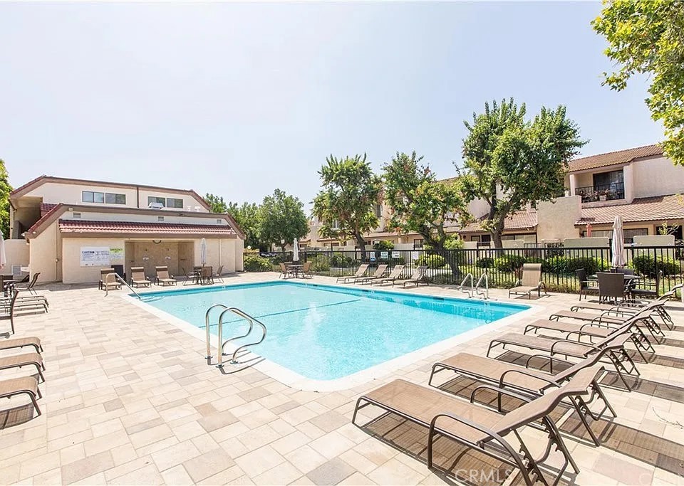 18146 Oxnard Street, Unit 48 Tarzana, CA 91356 - Photo 44 of 52 a view of a swimming pool with lounge chairs