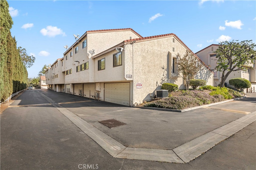 18146 Oxnard Street, Unit 48 Tarzana, CA 91356 - Photo 52 of 52 a view of a white house with a yard and street