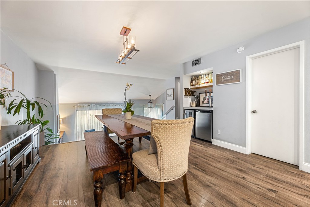 18146 Oxnard Street, Unit 48 Tarzana, CA 91356 - Photo 9 of 52 a view of a dining room with furniture and wooden floor
