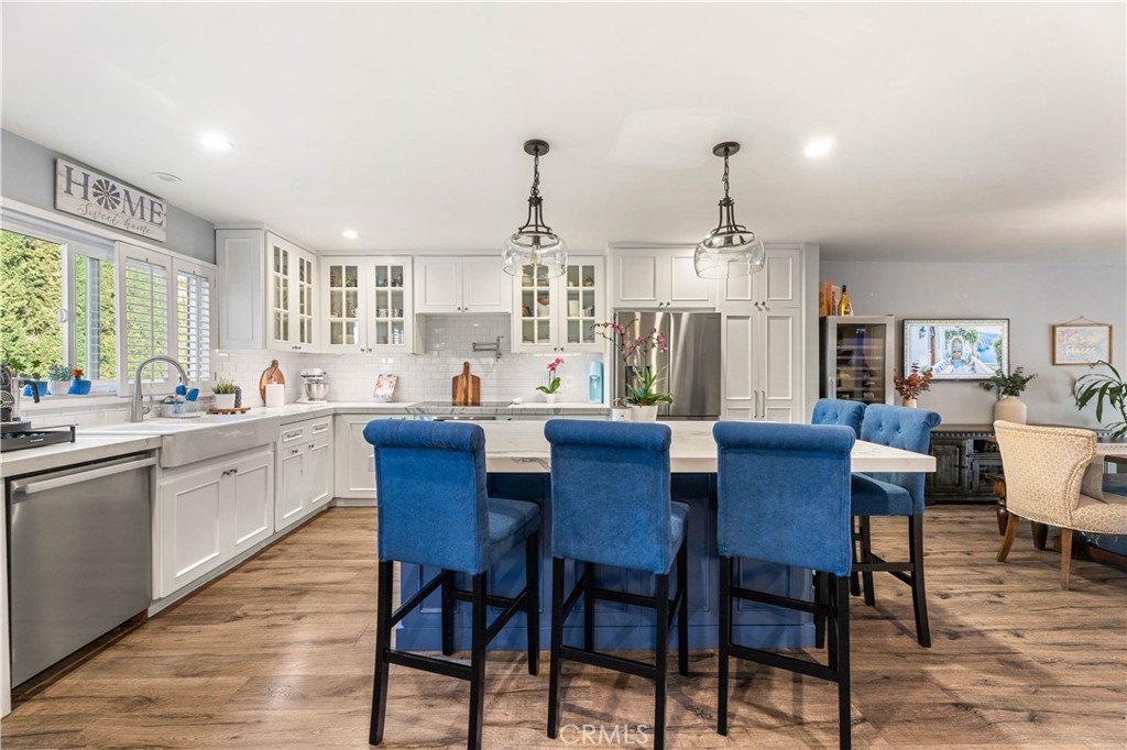 18146 Oxnard Street, Unit 48 Tarzana, CA 91356 - Photo 10 of 52 a view of a dining room with furniture window and wooden floor