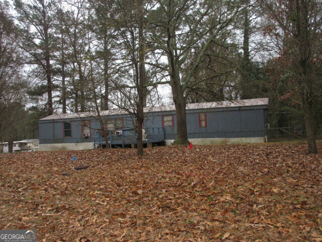220 Millers Mill Road Stockbridge, GA 30281 - Photo 2 of 3 a house with trees in front of it