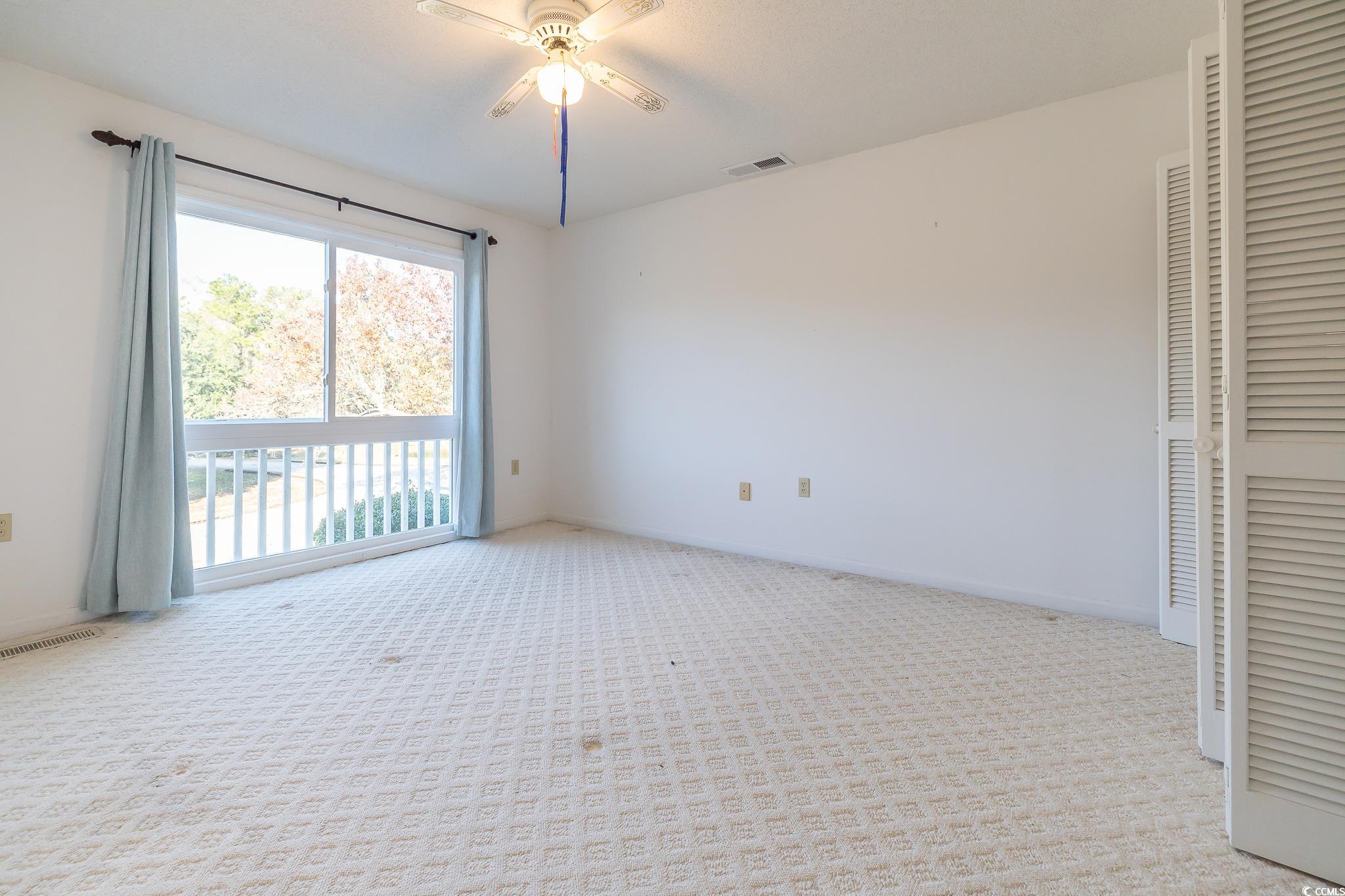 43 Pheasant Loop, Unit 302 Georgetown, SC 29440 - Photo 16 of 38 Unfurnished bedroom with light carpet and a ceiling fan