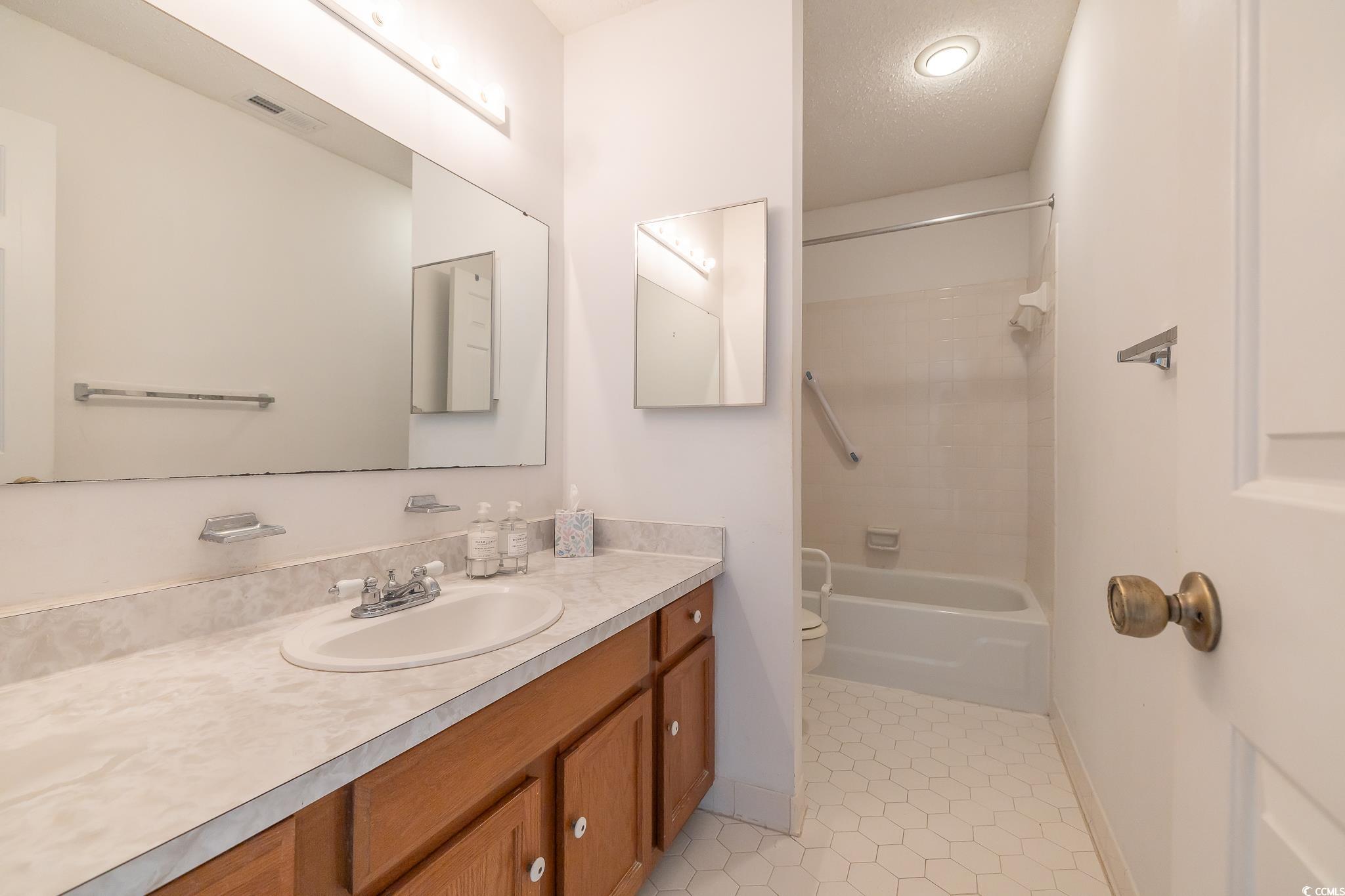 43 Pheasant Loop, Unit 302 Georgetown, SC 29440 - Photo 21 of 38 Full bath with vanity, bathtub / shower combination, and light tile patterned floors