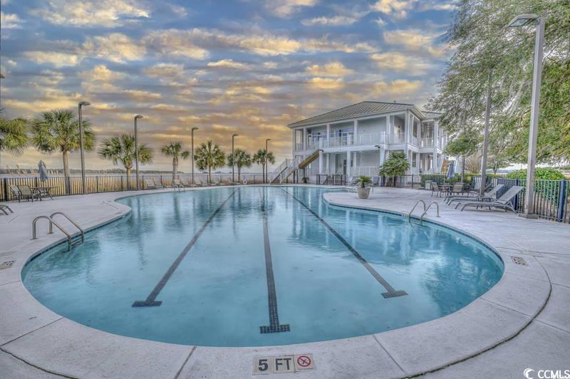 43 Pheasant Loop, Unit 302 Georgetown, SC 29440 - Photo 28 of 38 Community pool with a patio, stairs, and a balcony