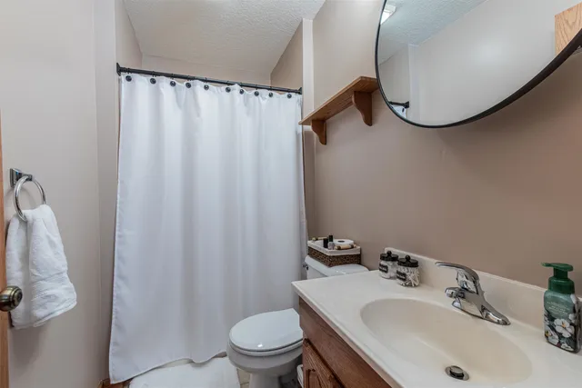 a bathroom with a sink toilet and mirror