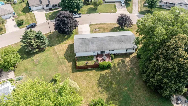 an aerial view of a house with a yard