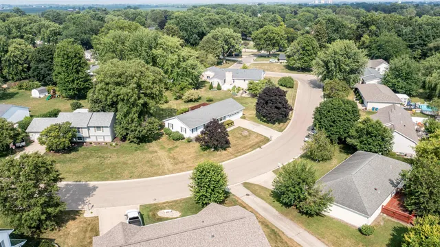 an aerial view of residential houses with outdoor space and street view