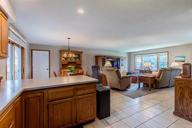 a view of living room with kitchen island furniture and a window