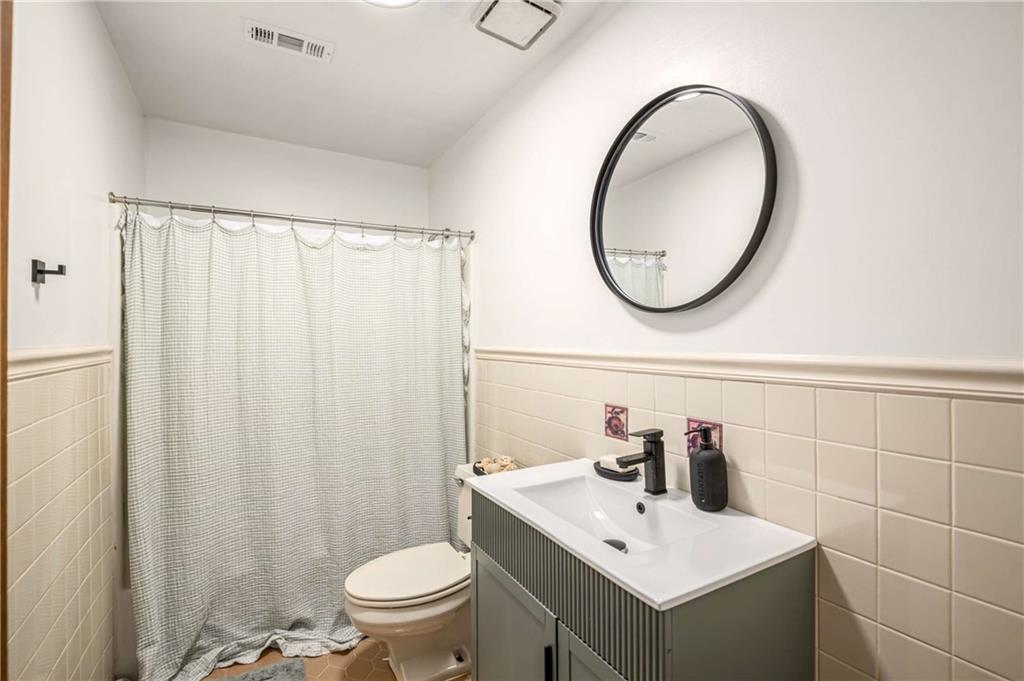 614 Robinson Avenue Southeast Atlanta, GA 30312 - Photo 23 of 74 a bathroom with a sink a toilet and a mirror