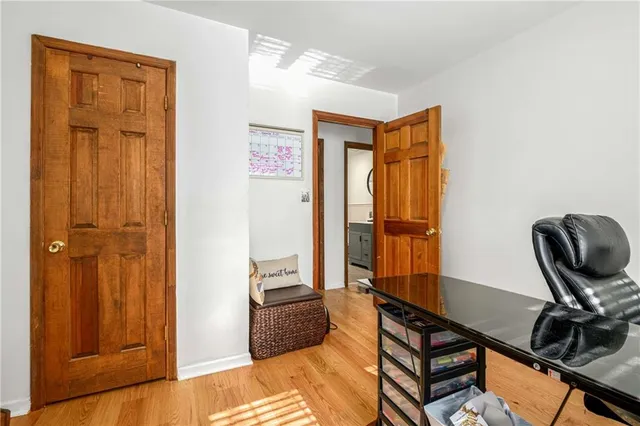 a living room with furniture a window and potted plants