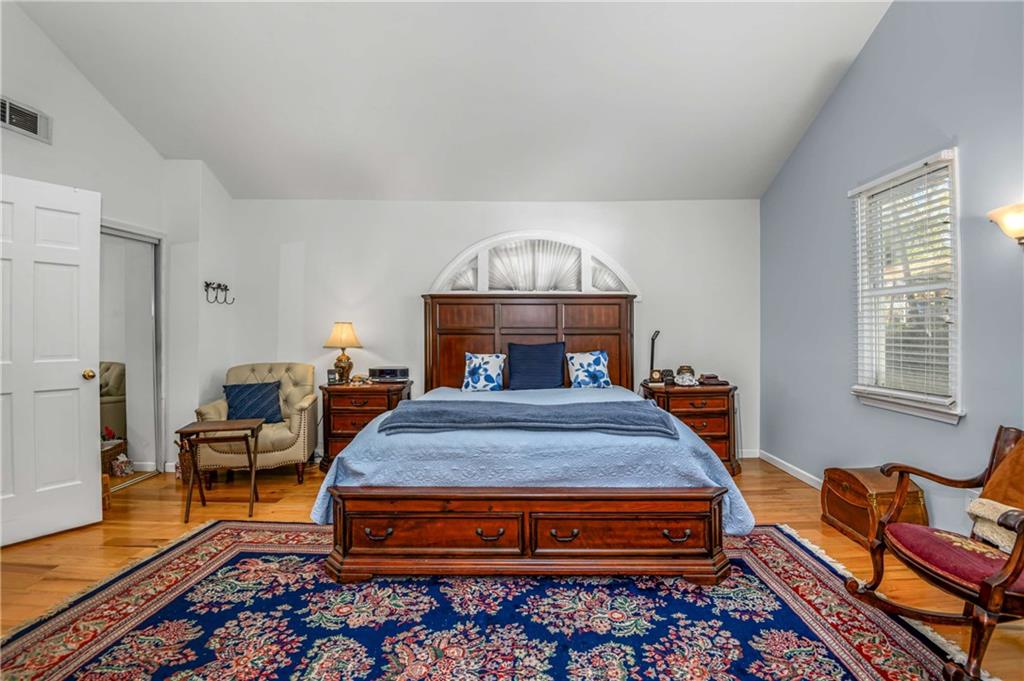 614 Robinson Avenue Southeast Atlanta, GA 30312 - Photo 27 of 74 a bedroom with a bed and wooden floor