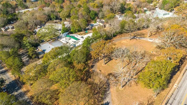 an outdoor cafe with a table and chairs under an umbrella