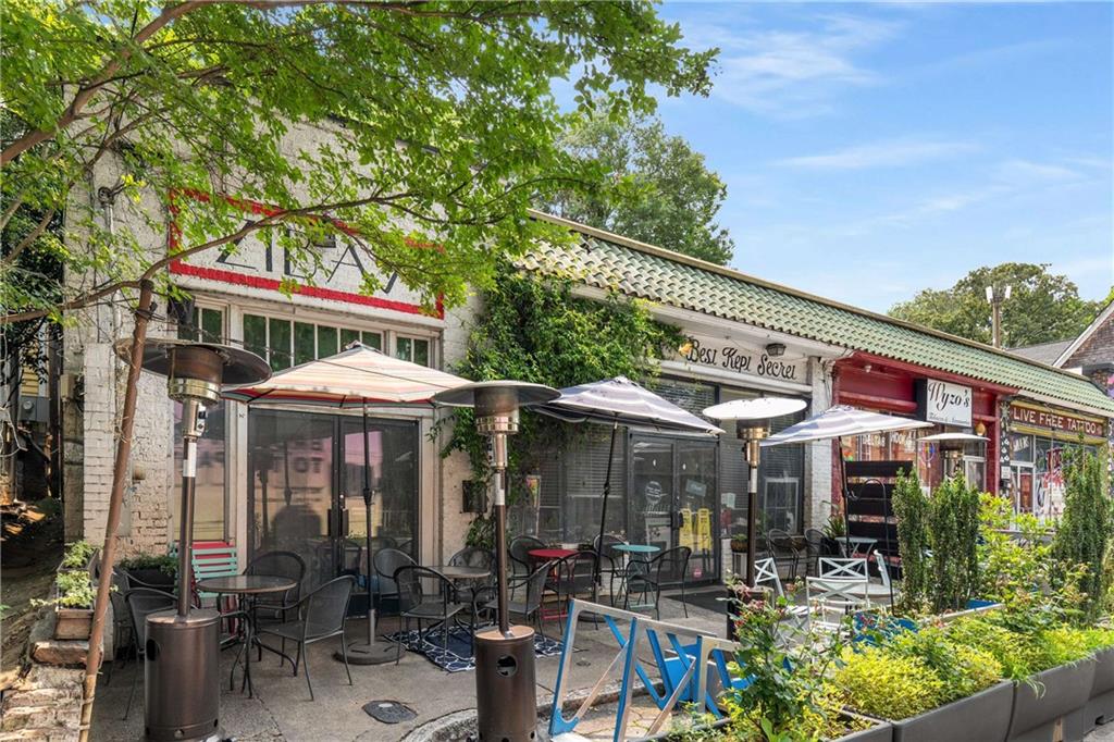 614 Robinson Avenue Southeast Atlanta, GA 30312 - Photo 49 of 74 an outdoor cafe with a table and chairs under an umbrella