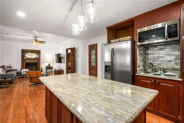 a kitchen with stainless steel appliances granite countertop plenty wooden cabinets