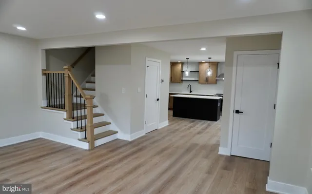 a view of a kitchen with wooden floor and electronic appliances