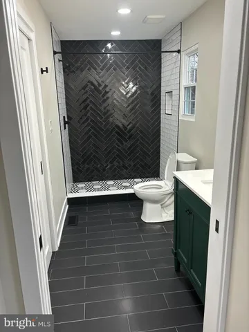 a bathroom with a sink toilet a mirror and vanity