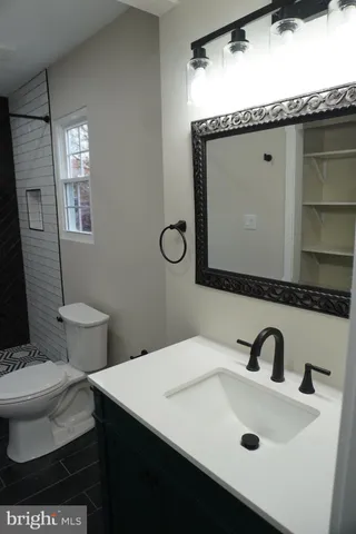 a bathroom with a toilet sink and mirror