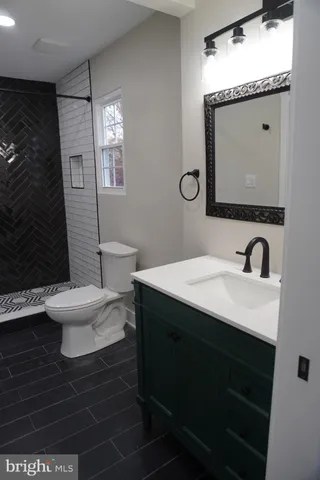 a bathroom with a toilet a sink and mirror