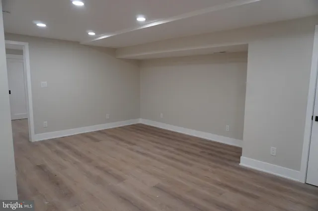 a view of room with wooden floor and fan