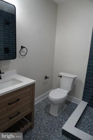 a bathroom with a toilet a sink and mirror