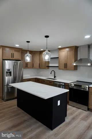 a kitchen with refrigerator cabinets and a sink