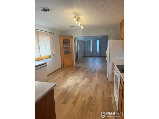 a view of a room with wooden floor and staircase