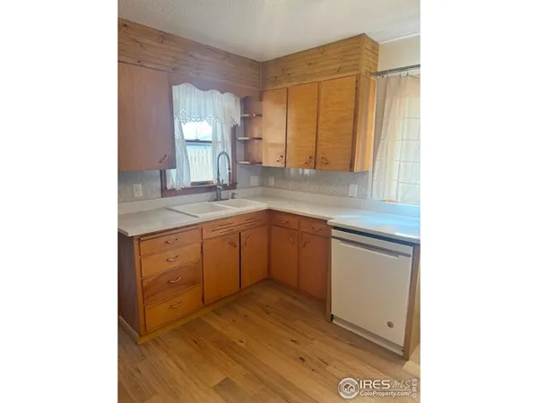 a kitchen with a sink cabinets and window