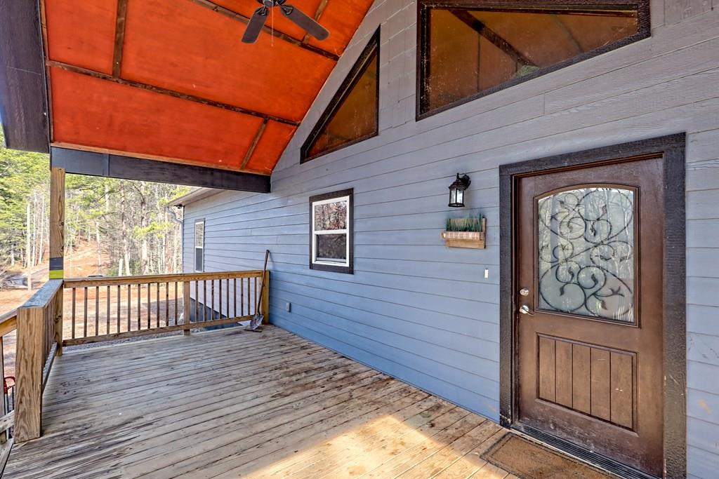 a view of a brick house with wooden floor in front of it