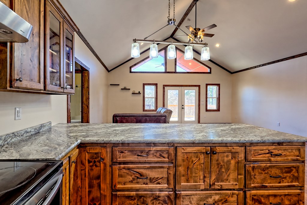 87 Mason Lane Marble, NC 28905 - Photo 13 of 66 a kitchen with kitchen island granite countertop wooden cabinets a dining table and chairs