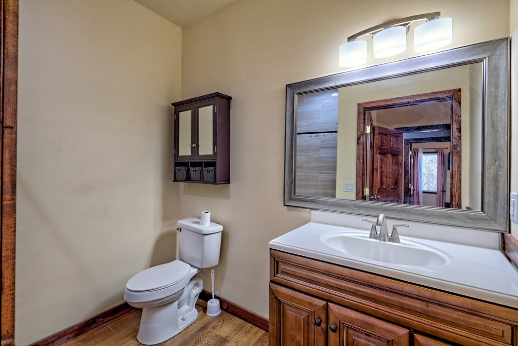 87 Mason Lane Marble, NC 28905 - Photo 43 of 66 a bathroom with a granite countertop toilet a sink and mirror