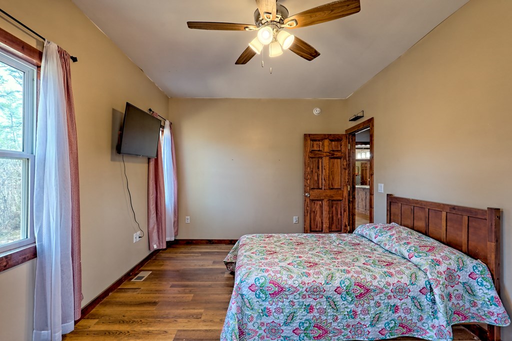 87 Mason Lane Marble, NC 28905 - Photo 50 of 66 a bedroom with a bed and a flat screen tv
