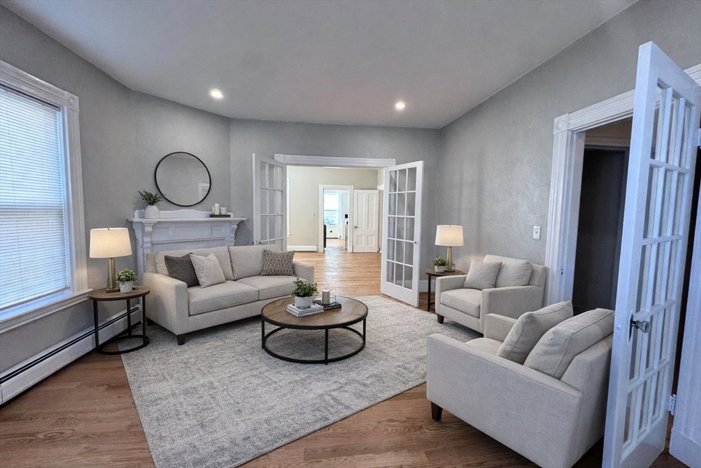 a living room with furniture and a large window