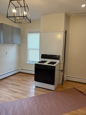 a kitchen with granite countertop a stove and a microwave