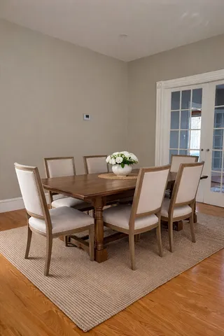a dining room with furniture and wooden floor