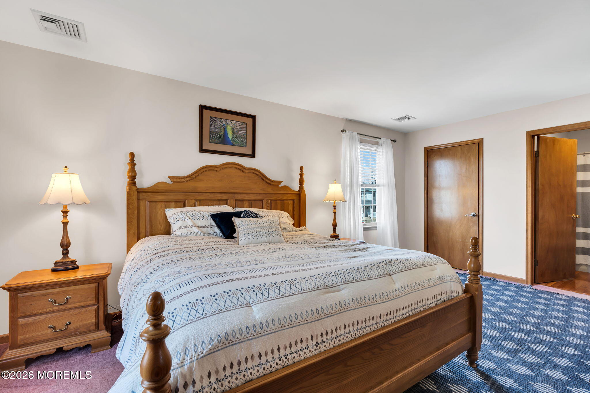 1706 Bay Avenue Point Pleasant, NJ 08742 - Photo 17 of 34 a bedroom with a bed and a lamp on dresser