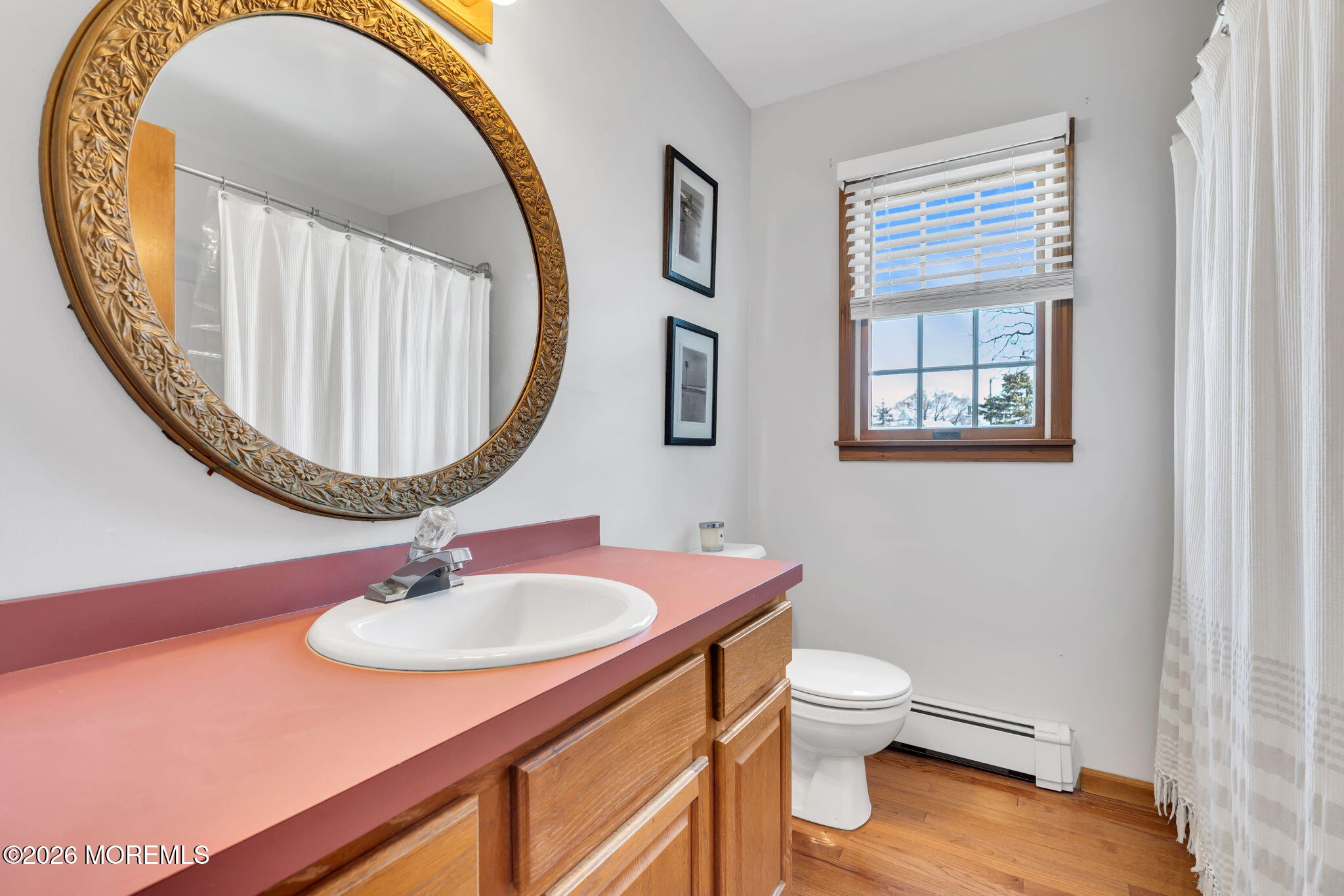 1706 Bay Avenue Point Pleasant, NJ 08742 - Photo 22 of 34 a bathroom with a sink a mirror and a toilet