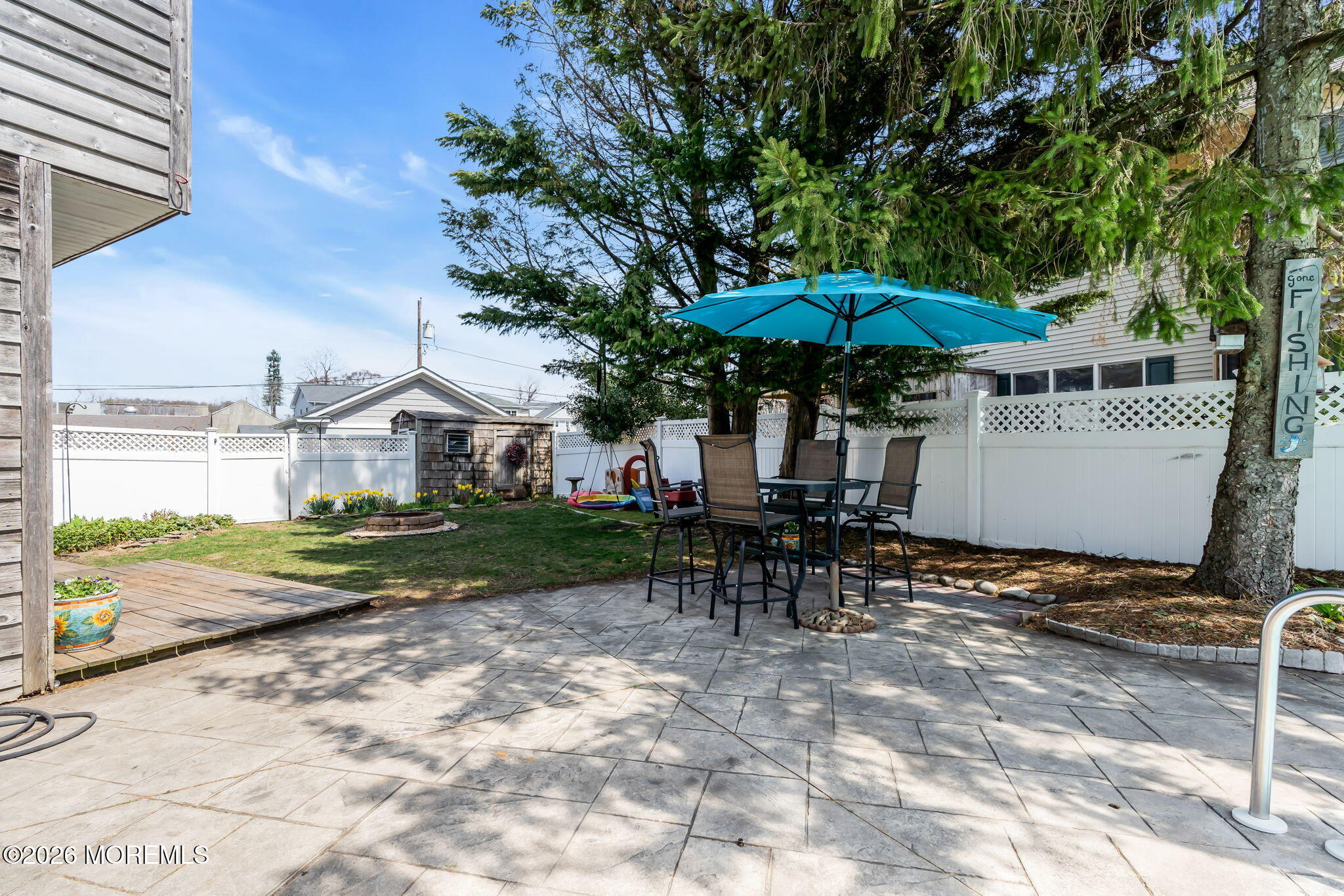 1706 Bay Avenue Point Pleasant, NJ 08742 - Photo 29 of 34 a view of a patio with a table and chairs under an umbrella