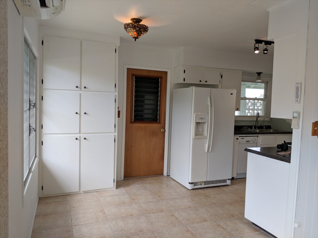 4547 Panihi Road Kapaa, HI 96746 - Photo 8 of 28 a kitchen with refrigerator and cabinets