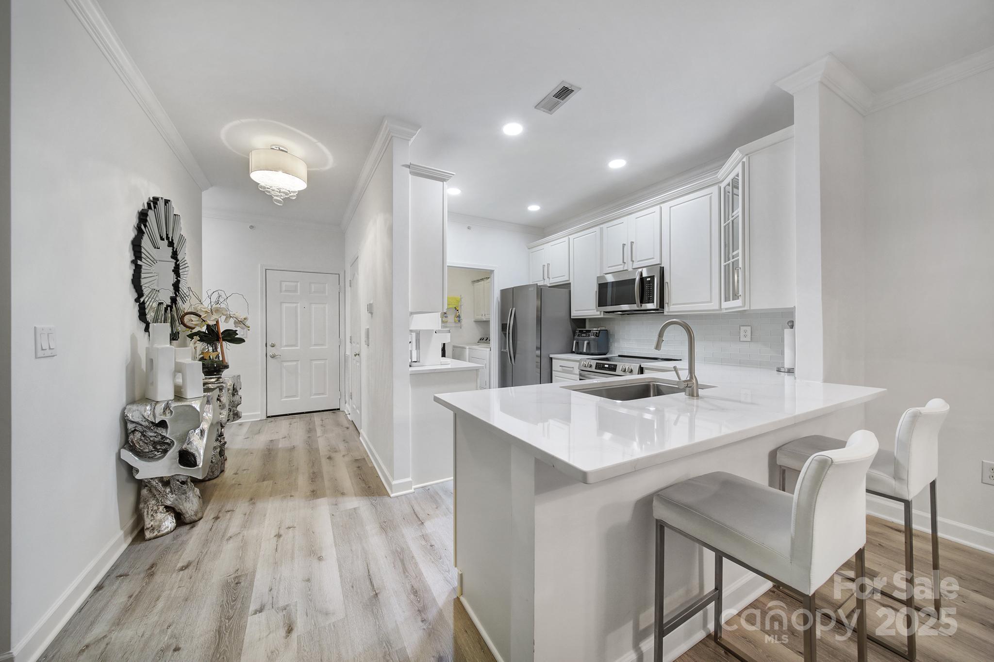 12355 Copper Mountain Boulevard Charlotte, NC 28277 - Photo 13 of 33 a kitchen with kitchen island a sink appliances and cabinets