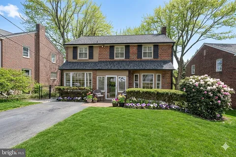 a front view of a house with a garden and plants