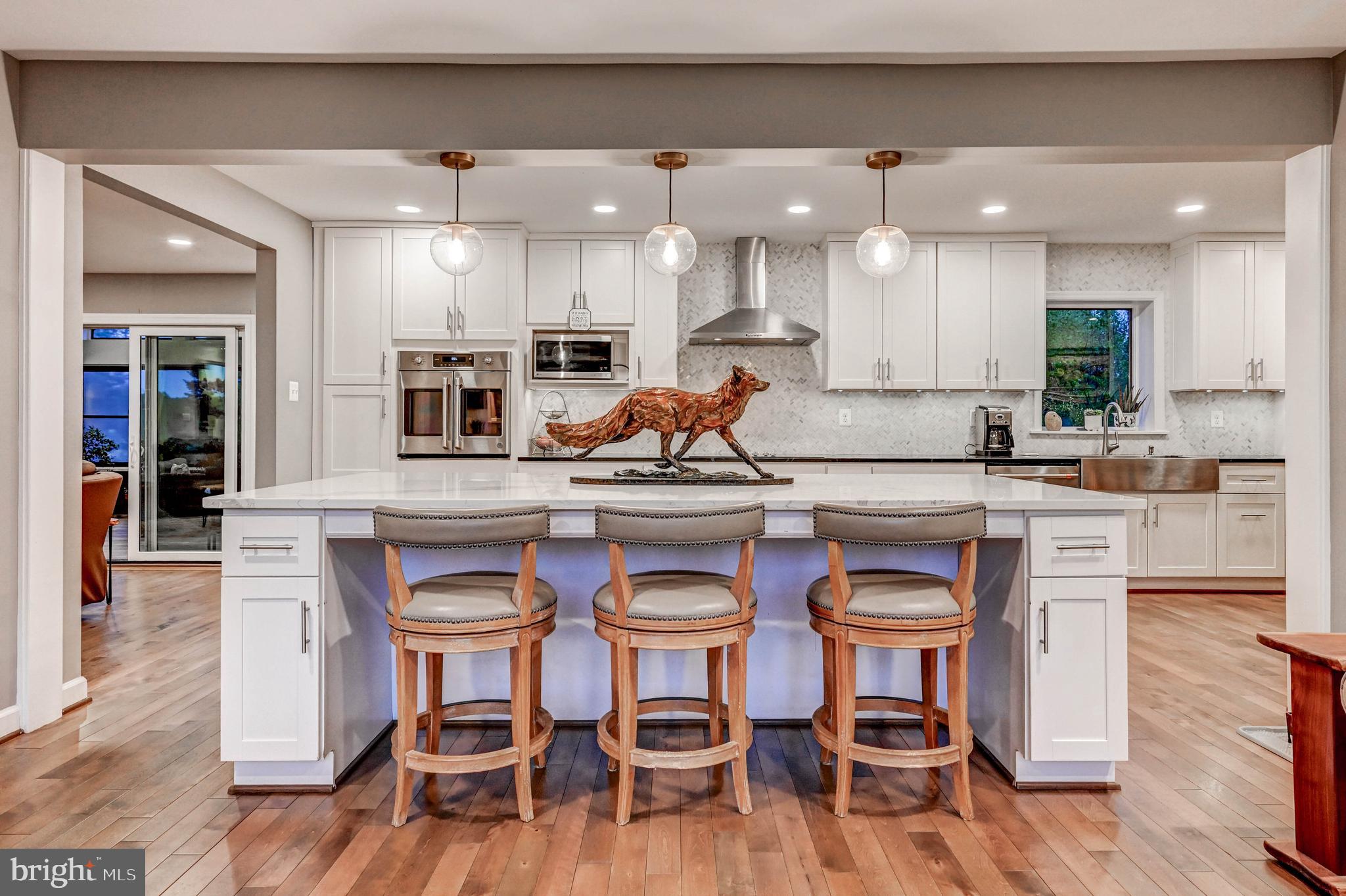 1111 Corbett Road Monkton, MD 21111 - Photo 7 of 33 a kitchen with stainless steel appliances kitchen island granite countertop a stove a sink a dining table and chairs