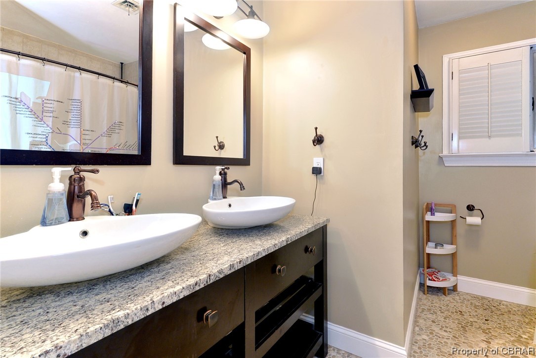 122 Selden Road Newport News, VA 23606 - Photo 21 of 38 Bathroom with tile floors, mirror, and double sink vanity