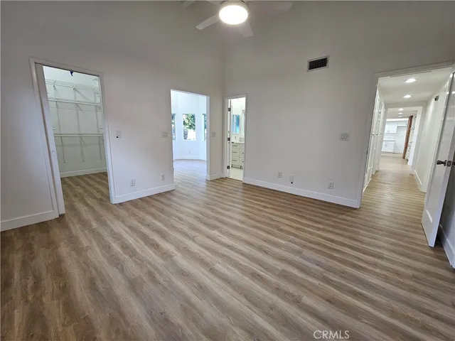 an empty room with wooden floor and entrance