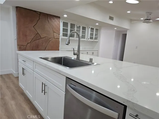 a kitchen with a sink and cabinets