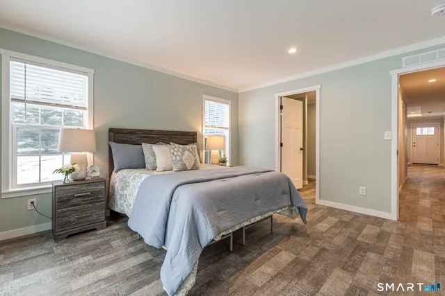 a bedroom with a bed and window