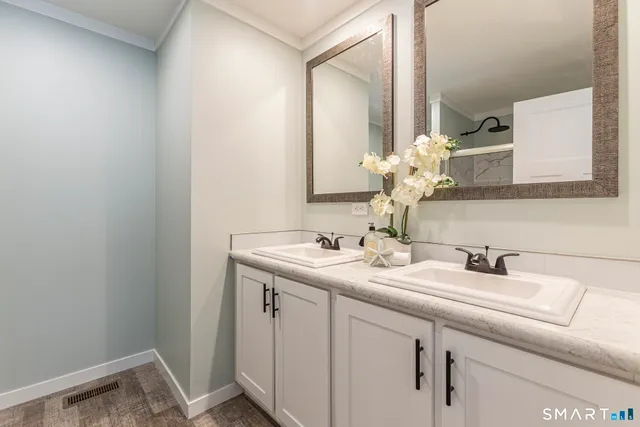 a en suite bathroom with a double vanity sink a and mirror