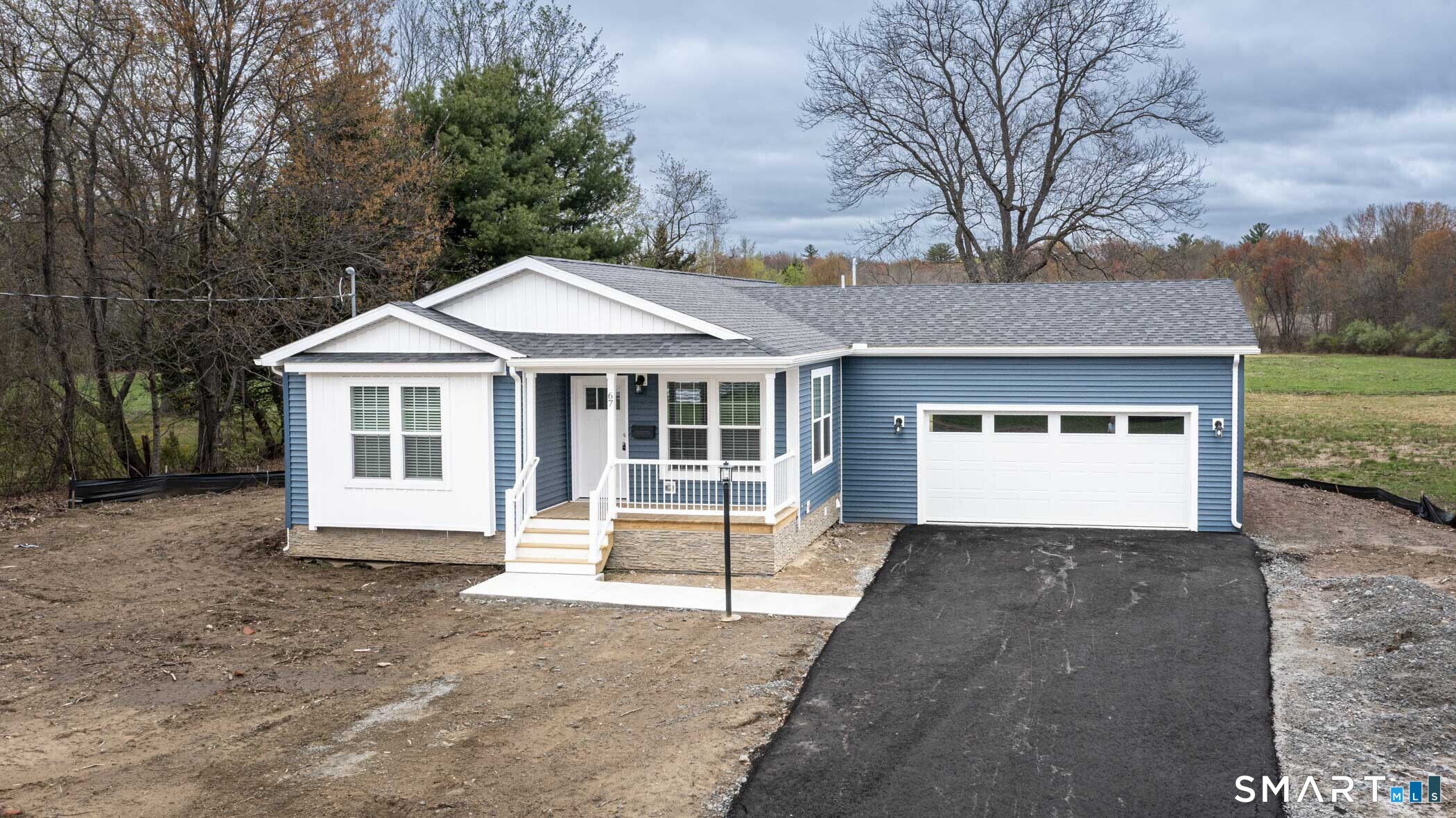 67 Middle Road Enfield, CT 06082 - Photo 2 of 43 a front view of a house with a yard and garage
