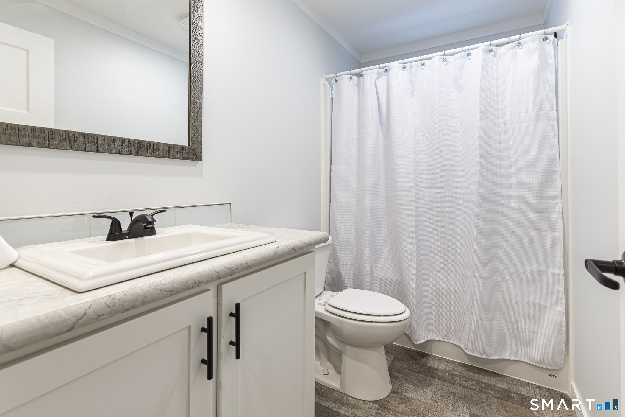 67 Middle Road Enfield, CT 06082 - Photo 24 of 43 a bathroom with a sink a toilet and a mirror