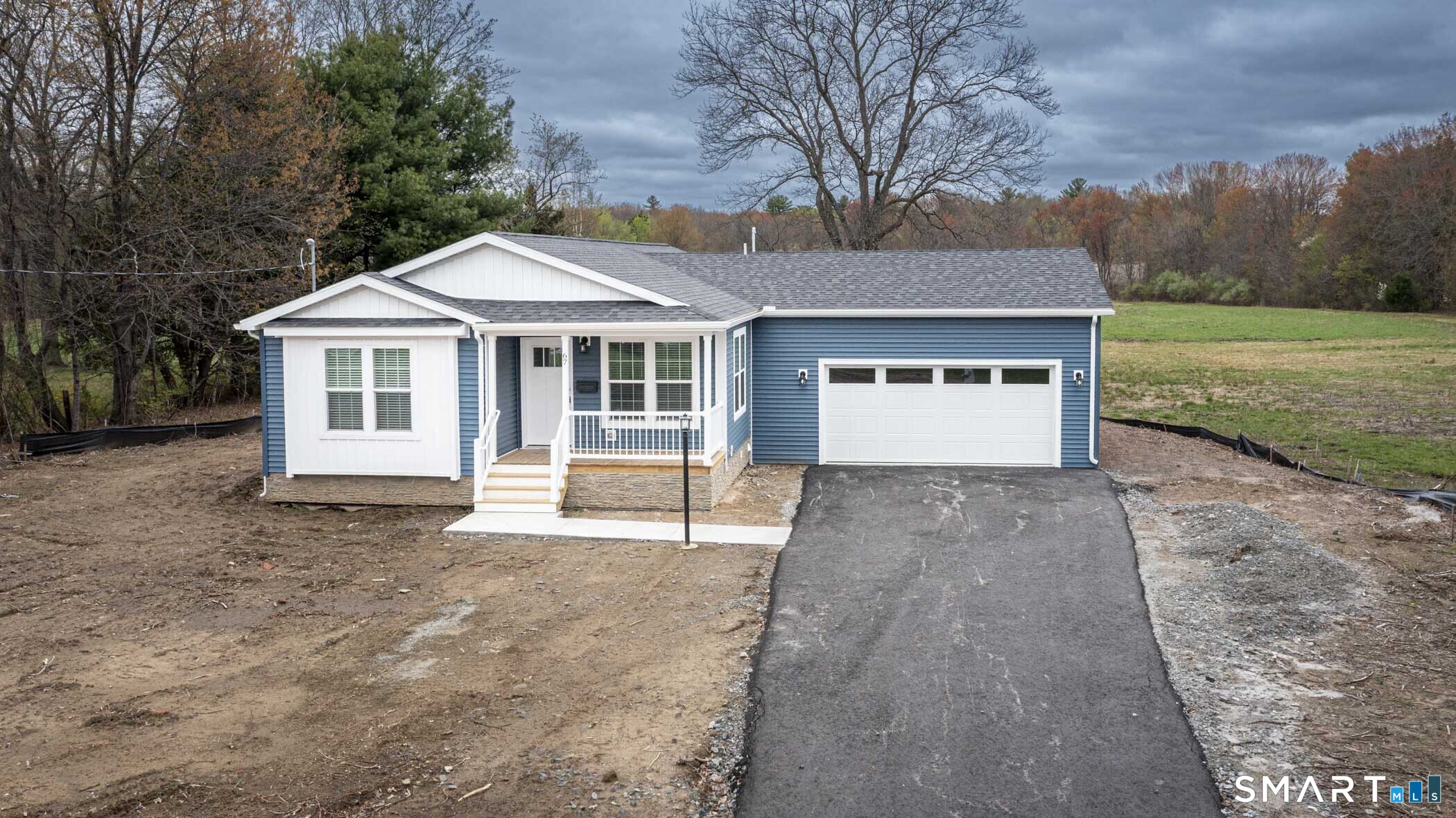 67 Middle Road Enfield, CT 06082 - Photo 43 of 43 a front view of a house with a yard and garage
